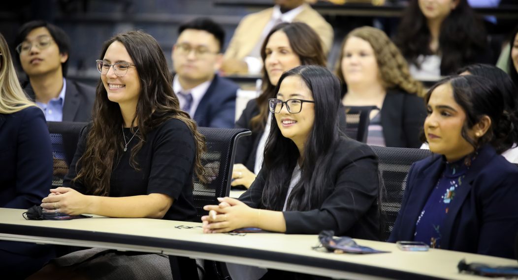group of students sitting and smiling